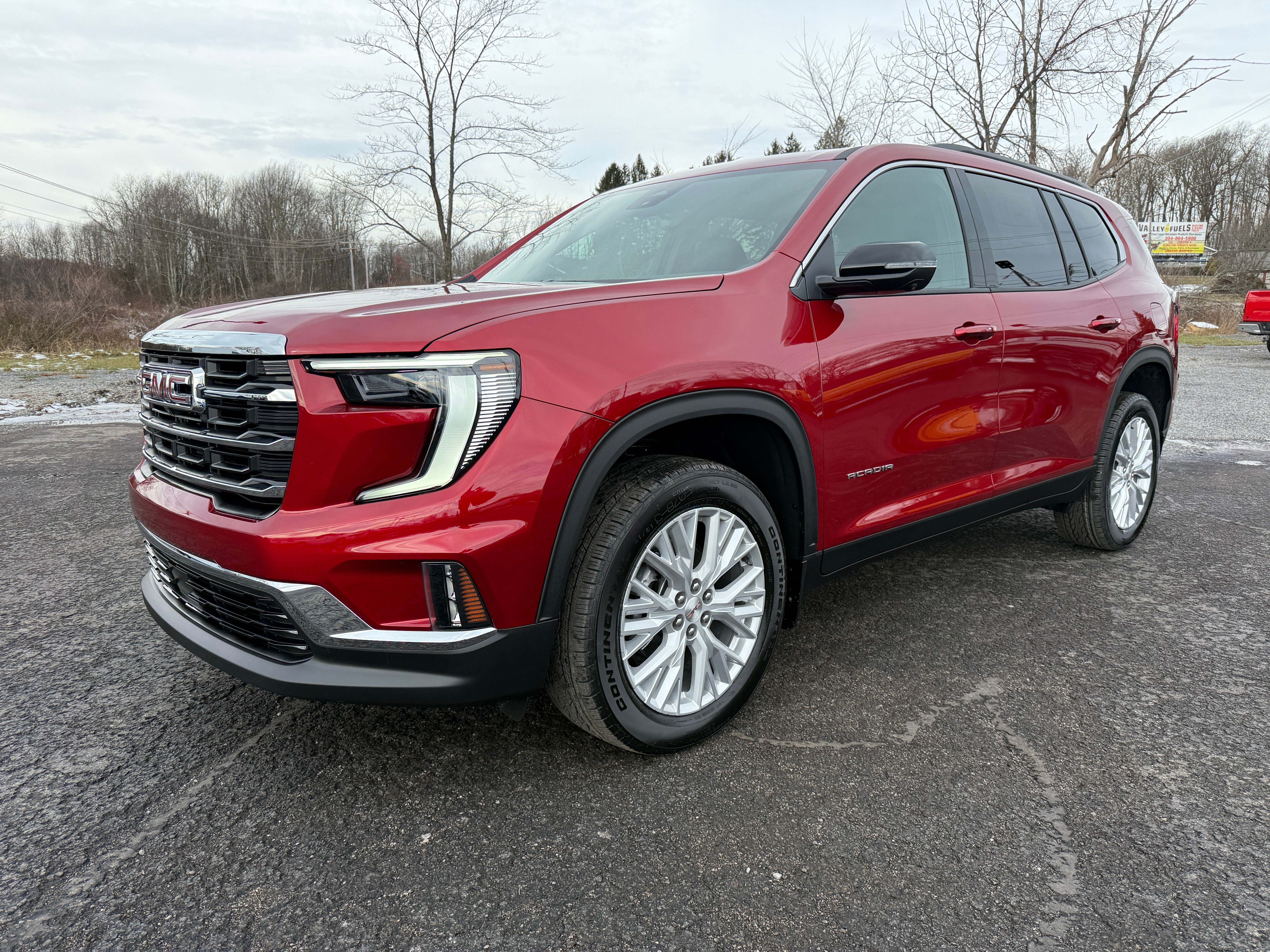 2026 GMC Acadia Elevation in Volcanic Red Tintcoat — front three-quarter view